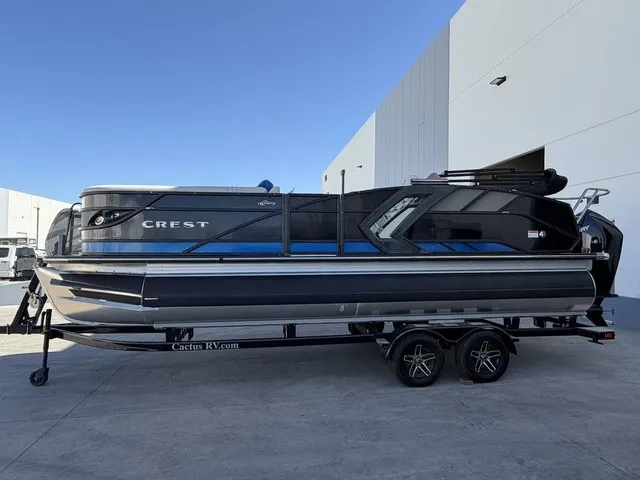 Slide: The Image of A 2023 Crest Caribbean LX 230 SLS CP3 pontoon boat on a trailer, parked in front of a modern building. - 6