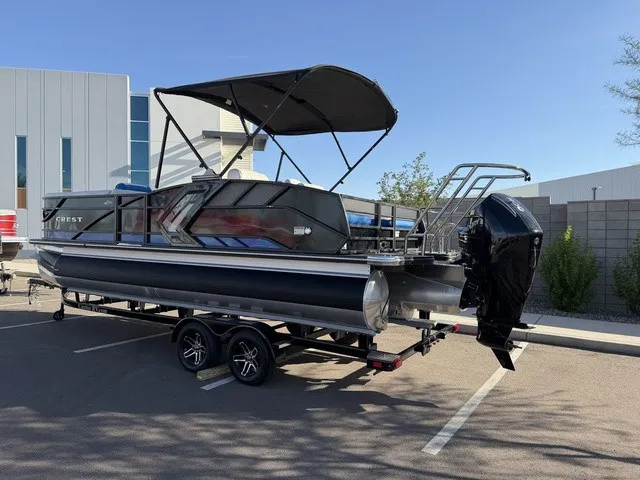 Slide: The Image of A modern pontoon boat with a black sunshade and powerful outboard motor, parked on a trailer. - 22