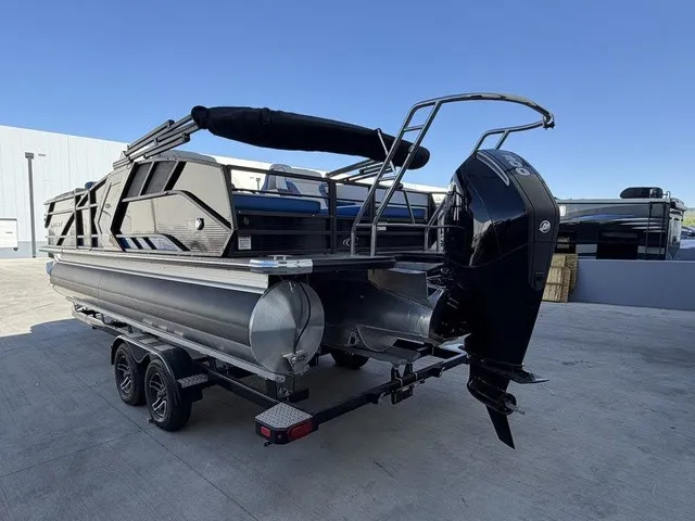 Slide: The Image of A 2023 Crest Caribbean LX 230 SLS CP3 pontoon boat on a trailer, featuring an outboard motor. - 18
