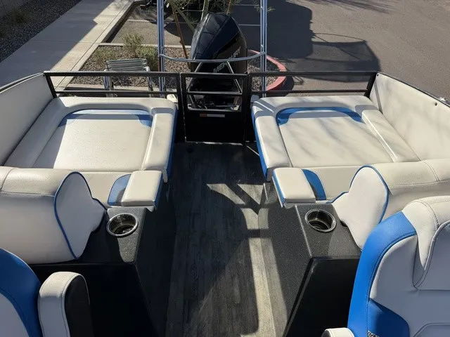 Slide: The Image of The image shows the deck of a 2023 Crest Caribbean LX 230 SLS CP3 boat with white and blue seating. - 13