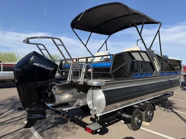 Slide: The Image of The image shows a 2023 Crest Caribbean LX 230 SLS CP3 pontoon boat with a black bimini top. - 23