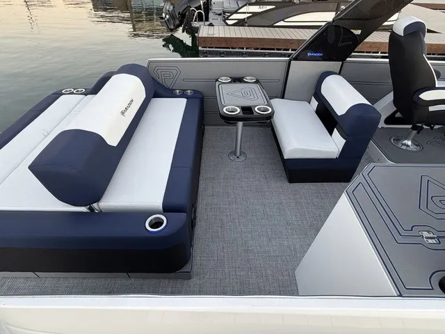 Slide: The Image of The image shows the interior of a 2023 Crest Caribbean LX 230 SLS CP3 with sleek seating and a table. - 19
