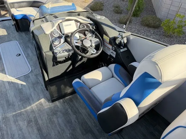 Slide: The Image of The image shows the cockpit of a 2023 Crest Caribbean LX 230 SLS CP3 with modern instruments and blue accents. - 16