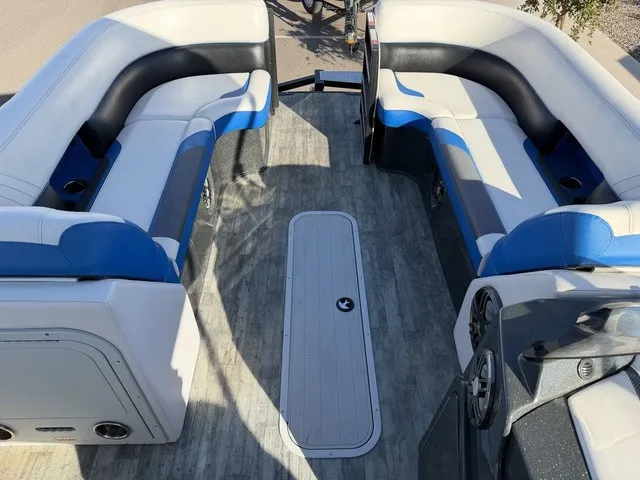 Slide: The Image of The image shows the interior of a 2023 Crest Caribbean LX 230 SLS CP3 boat with blue and white seating. - 14