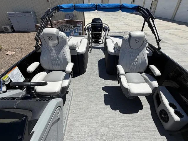 Slide: The Image of The image shows the interior of a 2022 Godfrey Pontoons Monaco 255 DFL 27 In. with luxurious seating. - 16