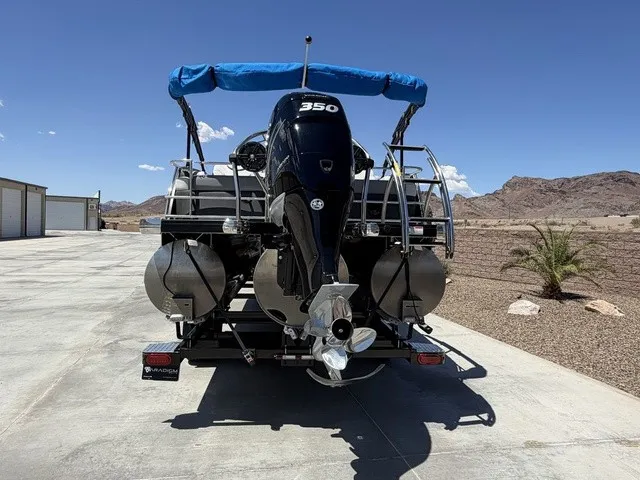 Slide: The Image of A 2022 Godfrey Pontoons Monaco 255 DFL 27 In. with a large outboard motor and blue canopy. - 20