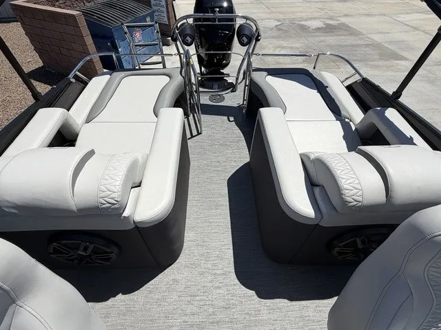 Slide: The Image of The image shows the interior of a 2022 Godfrey Pontoons Monaco 255 DFL 27 In. with luxurious seating. - 15