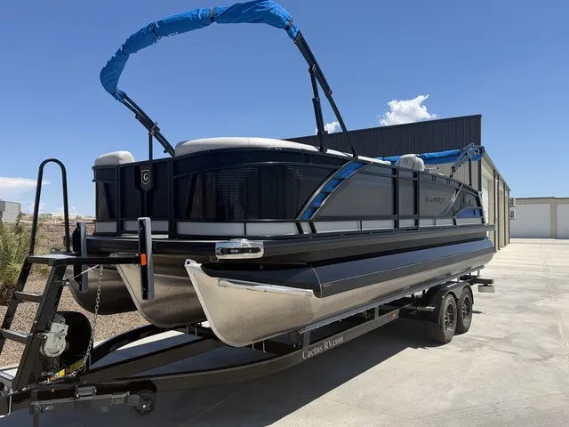 Slide: The Image of A 2022 Godfrey Pontoons Monaco 255 DFL 27 In. on a trailer, featuring a blue cover. - 19
