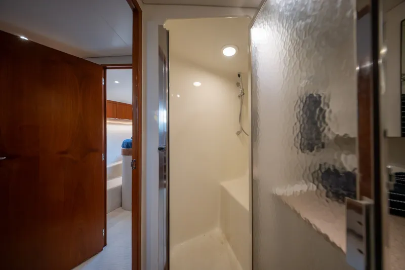 Slide: The Image of Luxurious 2001 Custom Carolina East Bay yacht interior with modern shower and wooden accents. - 47