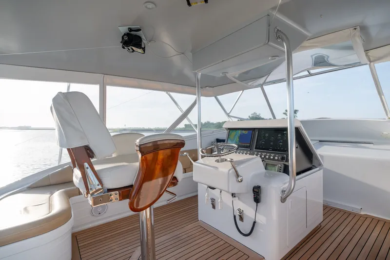 Slide: The Image of Helm of 2001 Custom Carolina East Bay yacht with modern controls and seating. - 18