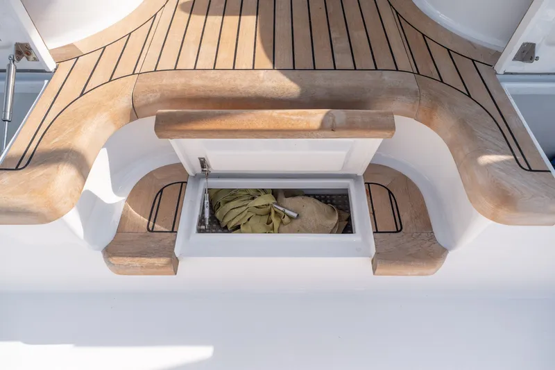 Slide: The Image of Teak deck of 2001 Custom Carolina East Bay boat with storage compartment open. - 37