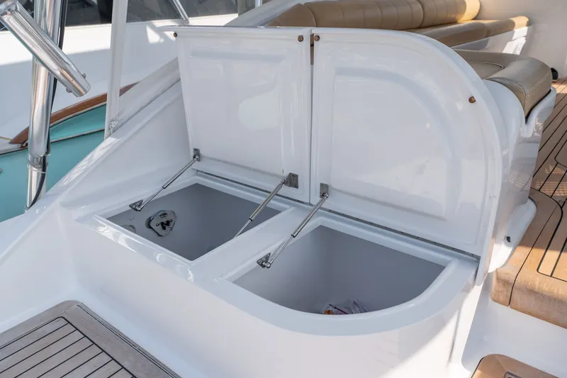 Slide: The Image of Open storage compartments on a 2001 Custom Carolina East Bay boat deck. - 35