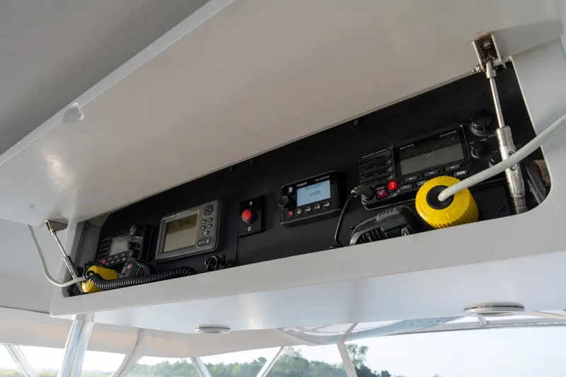 Slide: The Image of Control panel of a 2001 Custom Carolina East Bay boat with navigation and communication equipment. - 21