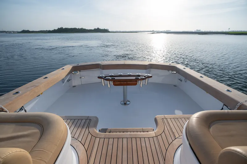 Slide: The Image of Custom Carolina East Bay 2001 boat deck overlooking serene water at sunrise. - 25