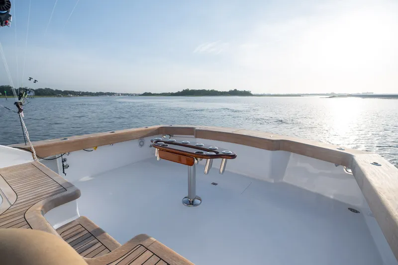 Slide: The Image of 2001 Custom Carolina East Bay boat deck overlooking serene waters at sunset. - 26