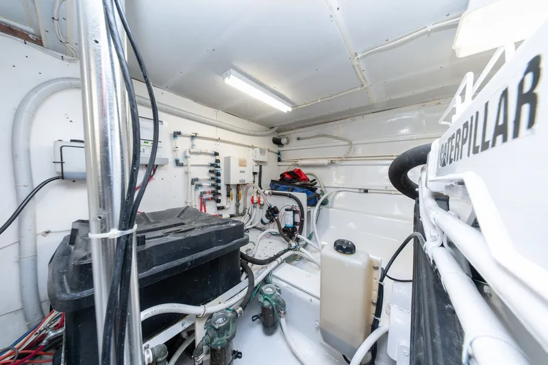 Slide: The Image of Engine room of 2001 Custom Carolina East Bay boat with Caterpillar machinery. - 54