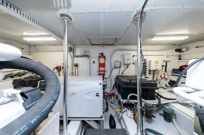 Slide: The Image of Engine room of 2001 Custom Carolina East Bay boat, featuring equipment and wiring. - 52