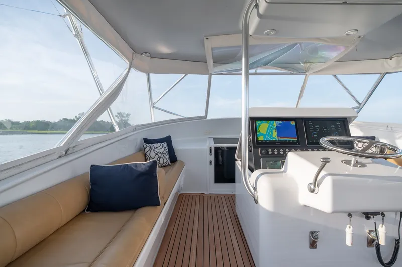Slide: The Image of Interior of 2001 Custom Carolina East Bay boat with navigation system and seating area. - 16