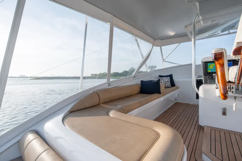 Slide: The Image of Interior of 2001 Custom Carolina East Bay boat with beige seating and wooden accents. - 14