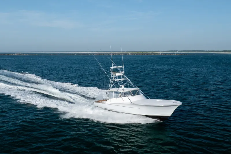 Slide: The Image of Custom Carolina East Bay 2001 yacht cruising on open water. - 12