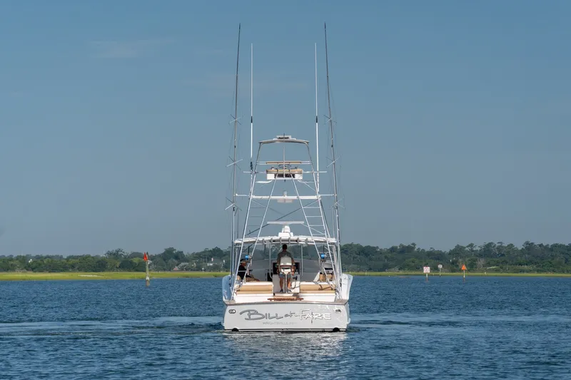 Slide: The Image of Custom Carolina East Bay 2001 boat cruising on a calm blue waterway. - 8