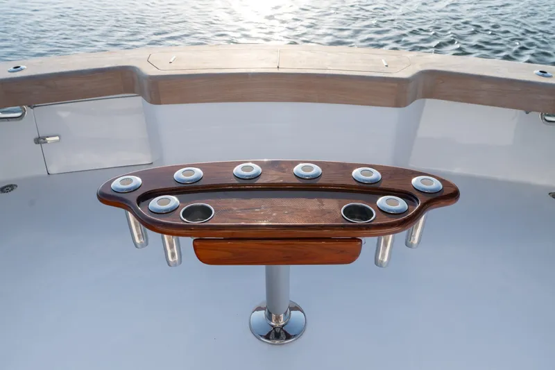 Slide: The Image of Cockpit of 2001 Custom Carolina East Bay boat with wooden fighting chair and rod holders. - 28