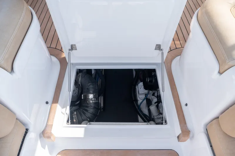 Slide: The Image of Open engine compartment of 2001 Custom Carolina East Bay boat, showcasing interior components. - 36