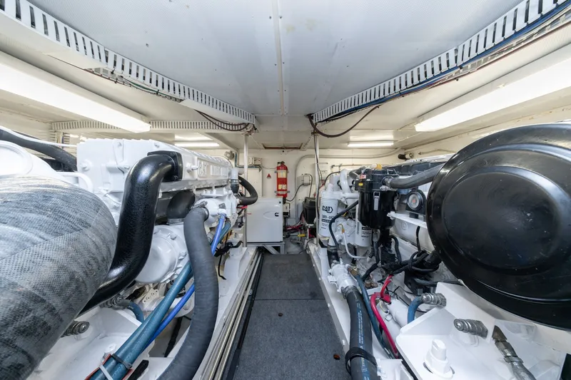 Slide: The Image of Engine room of 2001 Custom Carolina East Bay boat, featuring well-maintained machinery and equipment. - 49