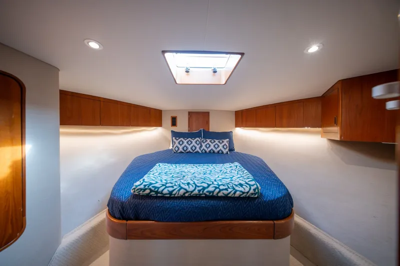 Slide: The Image of Luxurious cabin interior of 2001 Custom Carolina East Bay yacht with cozy bed and wooden cabinets. - 48