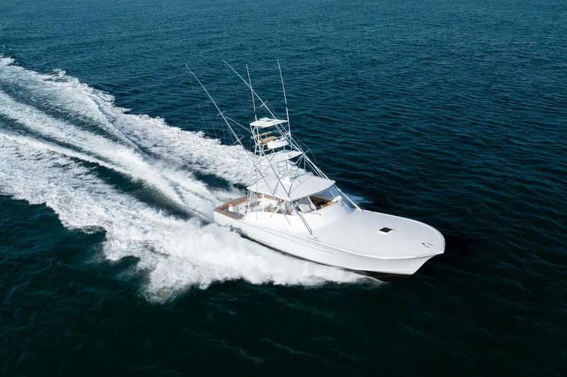 Slide: The Image of Custom Carolina East Bay 2001 yacht cruising swiftly on open ocean waters. - 3