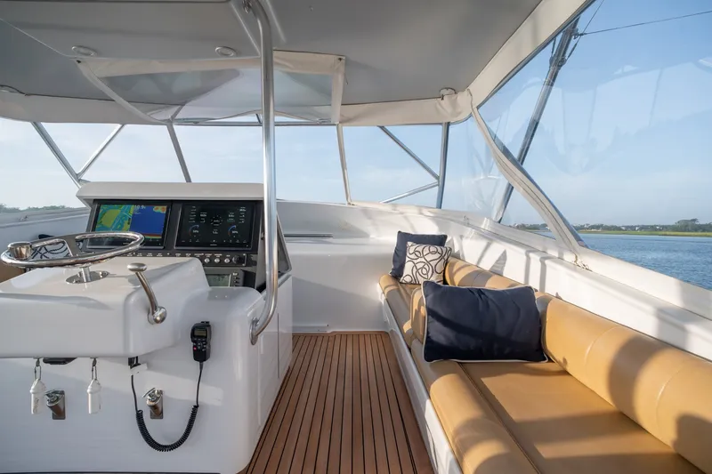 Slide: The Image of Interior of 2001 Custom Carolina East Bay boat with helm and cushioned seating. - 17