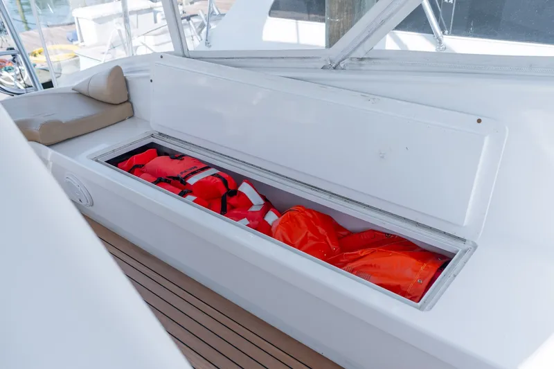 Slide: The Image of Storage compartment on 2001 Custom Carolina East Bay boat with life jackets inside. - 33