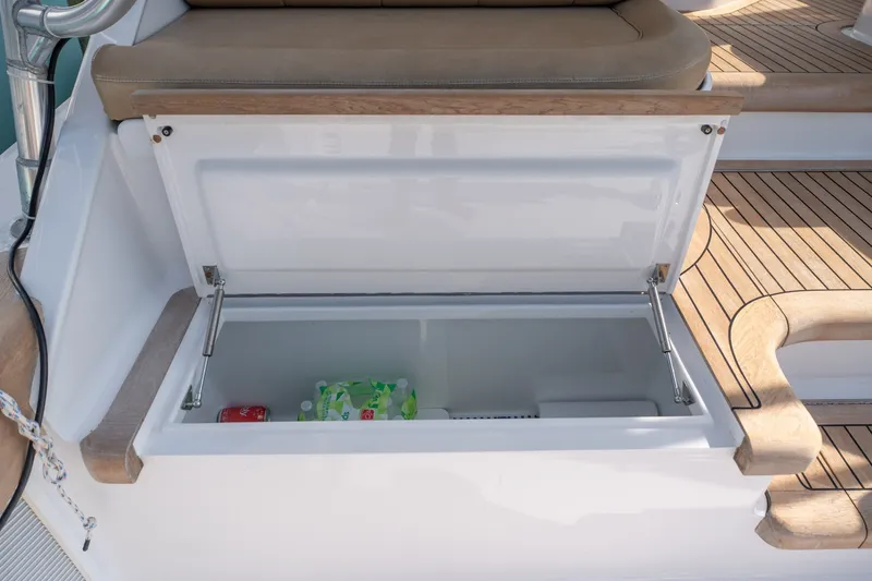 Slide: The Image of Open storage compartment on 2001 Custom Carolina East Bay boat with beverages inside. - 38