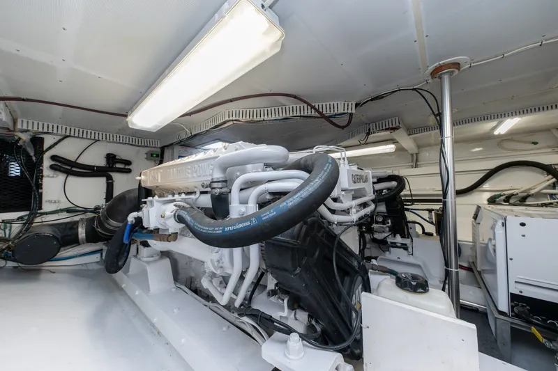 Slide: The Image of Engine room of 2001 Custom Carolina East Bay boat, featuring Caterpillar marine engine. - 50
