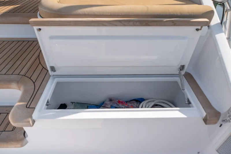 Slide: The Image of Open storage compartment on 2001 Custom Carolina East Bay boat with rope and supplies. - 39