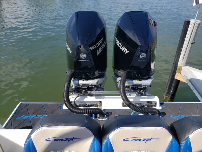 Slide: The Image of Two Mercury outboard engines on a Concept 30' Open Deck boat, resting on calm water. - 25