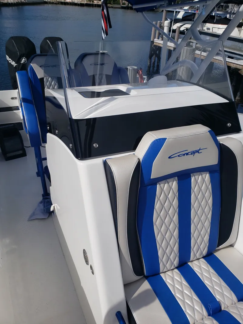 Slide: The Image of The image shows the cockpit of a 2020 Concept 30' Open Deck boat with blue and white seats. - 18