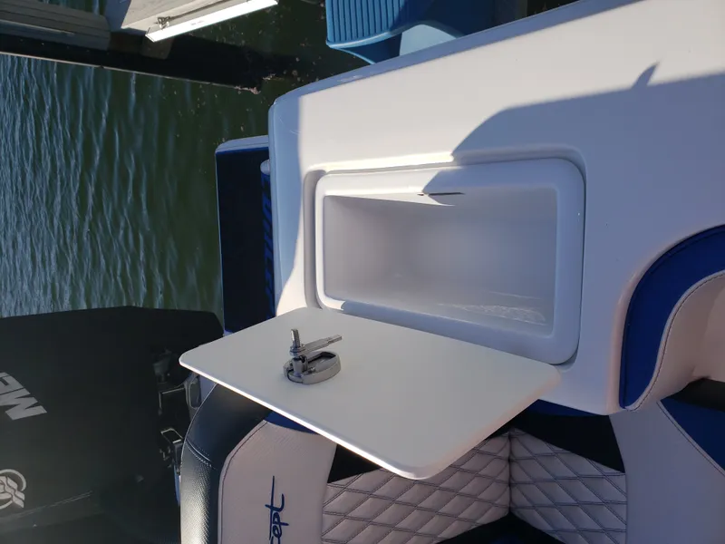Slide: The Image of A white boat with blue accents features an open storage compartment lid and a motor in the background. - 19