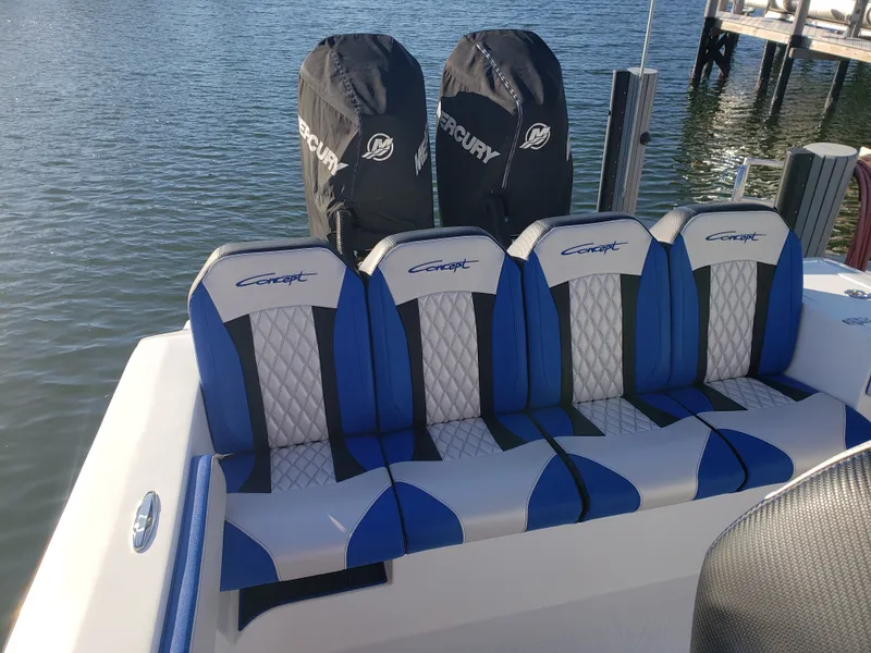 Slide: The Image of The image shows a boat's rear seats with blue and white upholstery and two outboard engines. - 21