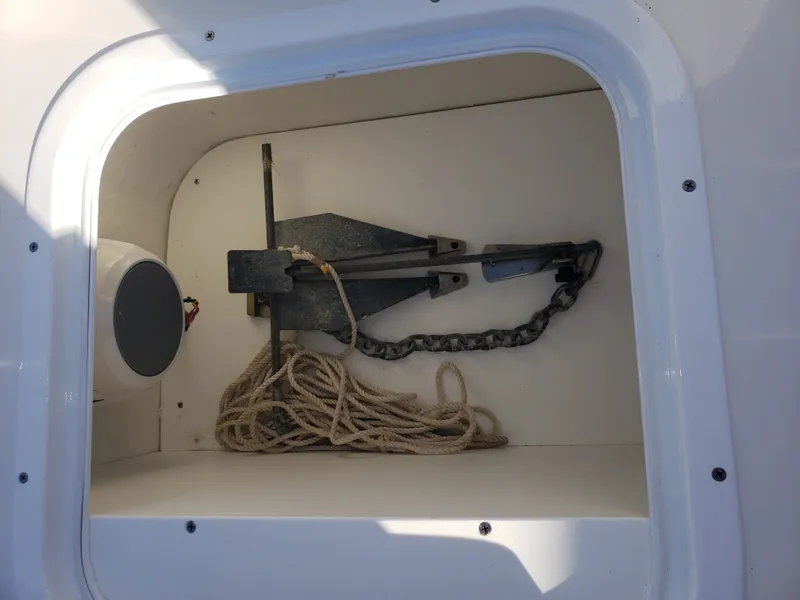 Slide: The Image of An anchor locker with an anchor, chain, and rope on a boat. - 23