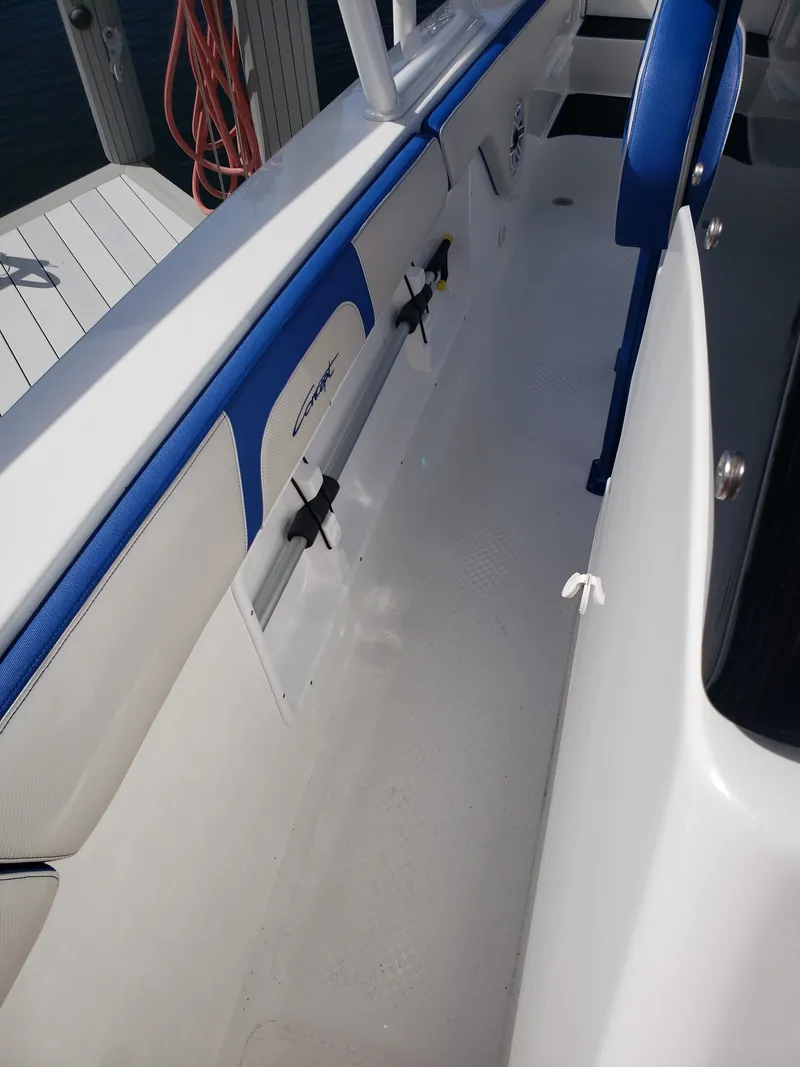 Slide: The Image of The image shows the deck of a 2020 Concept 30' Open Deck boat with blue and white seating. - 7