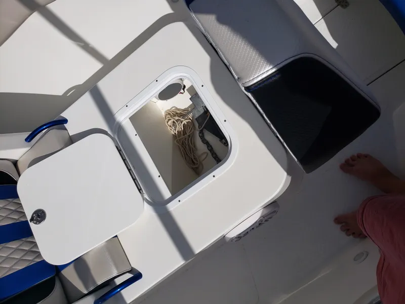 Slide: The Image of An open deck with storage compartment, ropes, and blue accents on the seats. - 20