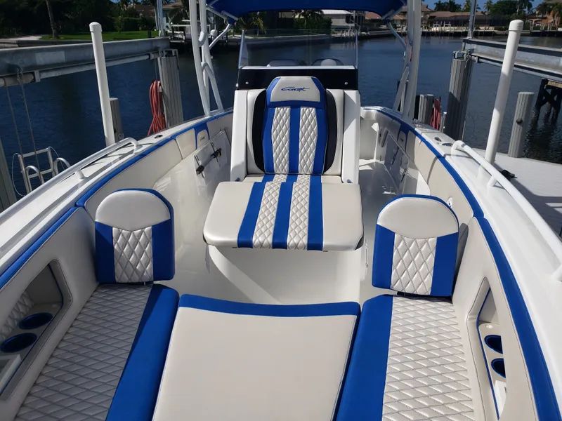 Slide: The Image of The boat features an open deck with blue and white upholstery, situated at a dock. - 4