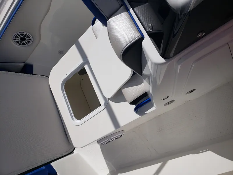 Slide: The Image of The image shows the cockpit of a 2020 Concept 30' Open Deck boat with white and blue upholstery. - 17
