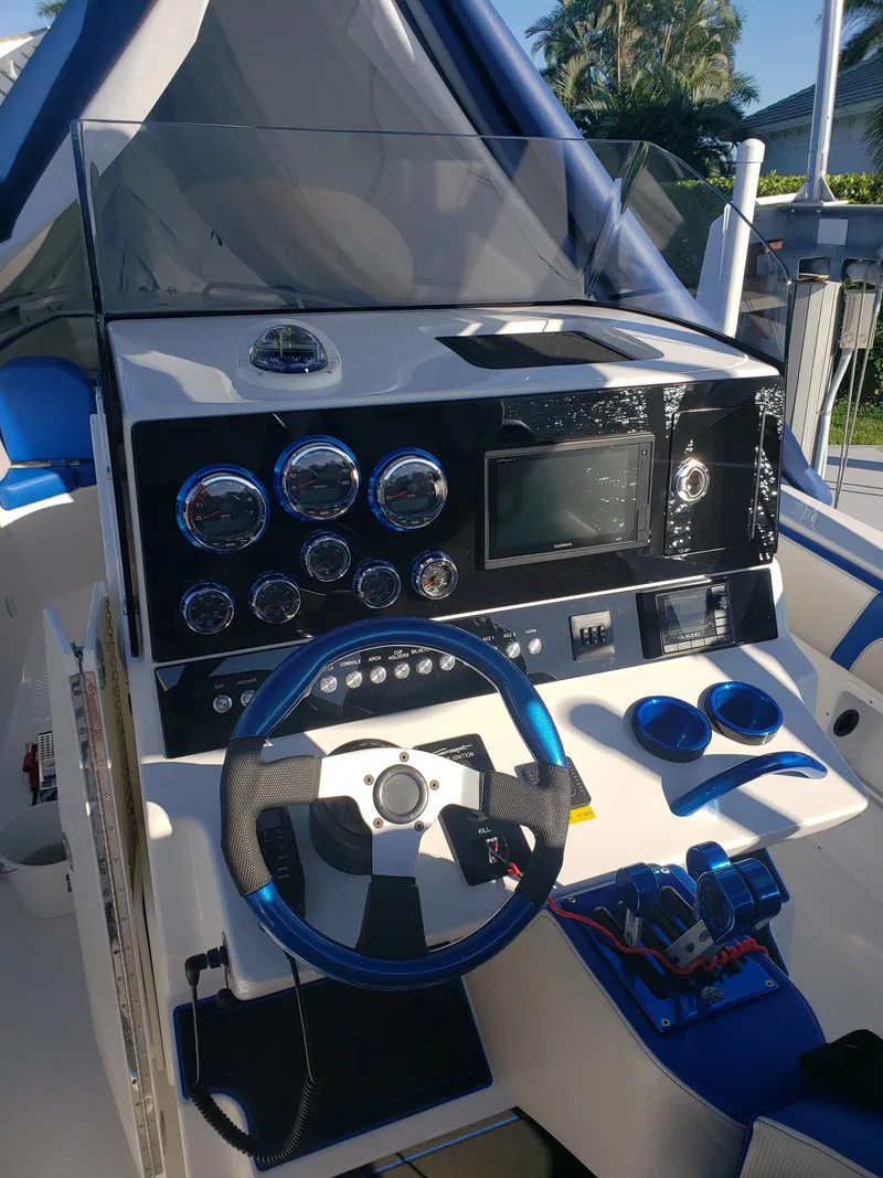 Slide: The Image of The image shows the helm of a 2020 Concept 30' Open Deck boat with blue accents. - 9
