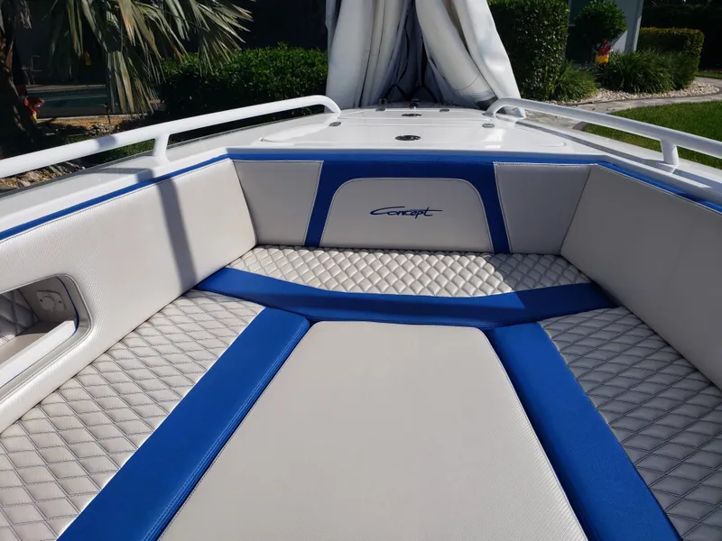 Slide: The Image of The image shows the open deck of a 2020 Concept 30' boat with blue and white upholstery. - 5