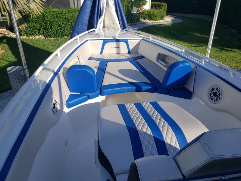 Slide: The Image of The image shows the open deck of a 2020 Concept 30' boat with blue and white upholstery. - 3