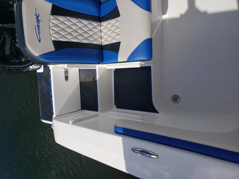 Slide: The Image of The image shows the cockpit of a 2020 Concept 30' Open Deck boat with blue and white seating. - 16