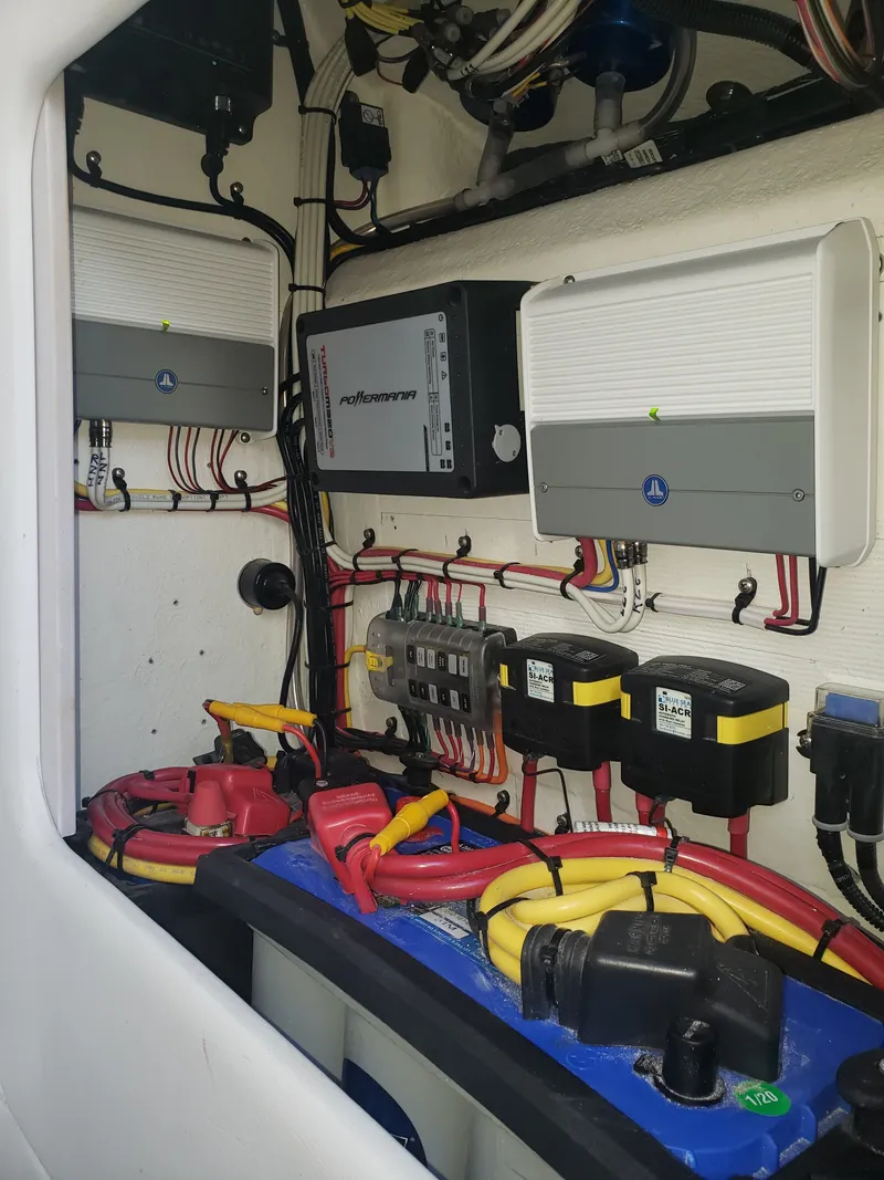 Slide: The Image of Electronics and wiring systems inside a boat, featuring various devices and cables. - 12