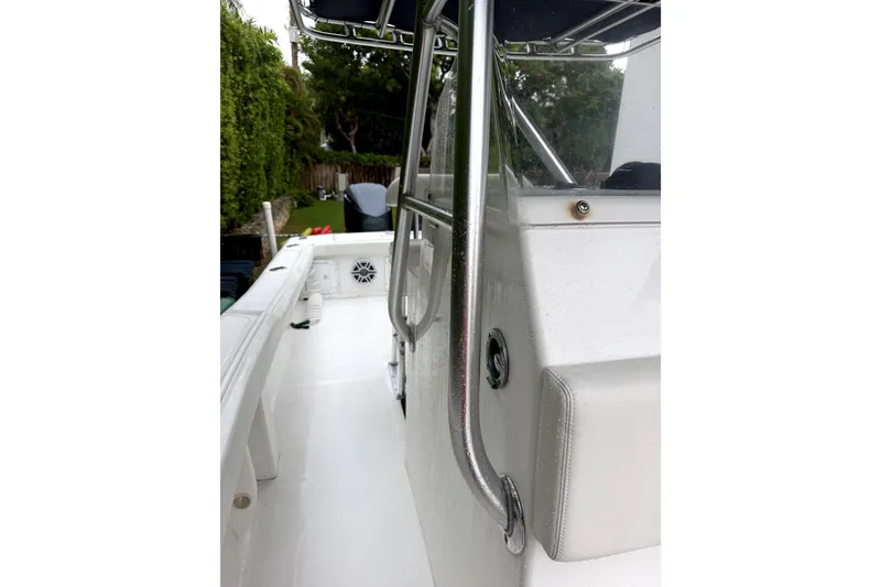 Slide: The Image of Interior view of a 2000 Ocean Runner 27 boat, featuring sleek white surfaces and metal railings. - 16